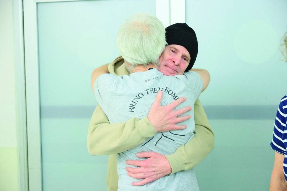 Released American-Israeli hostage, Keith Siegel, embraces a loved one in Tel Aviv, Israel, Saturday.