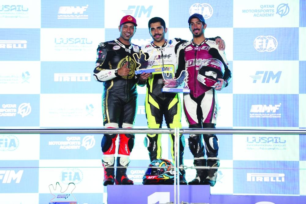 
QSTK 600 champion Abdulla al-Qubaisi, runner-up Mashel al-Naimi and third-placed Saeed al-Sulaiti pose on the podium with their trophies. 