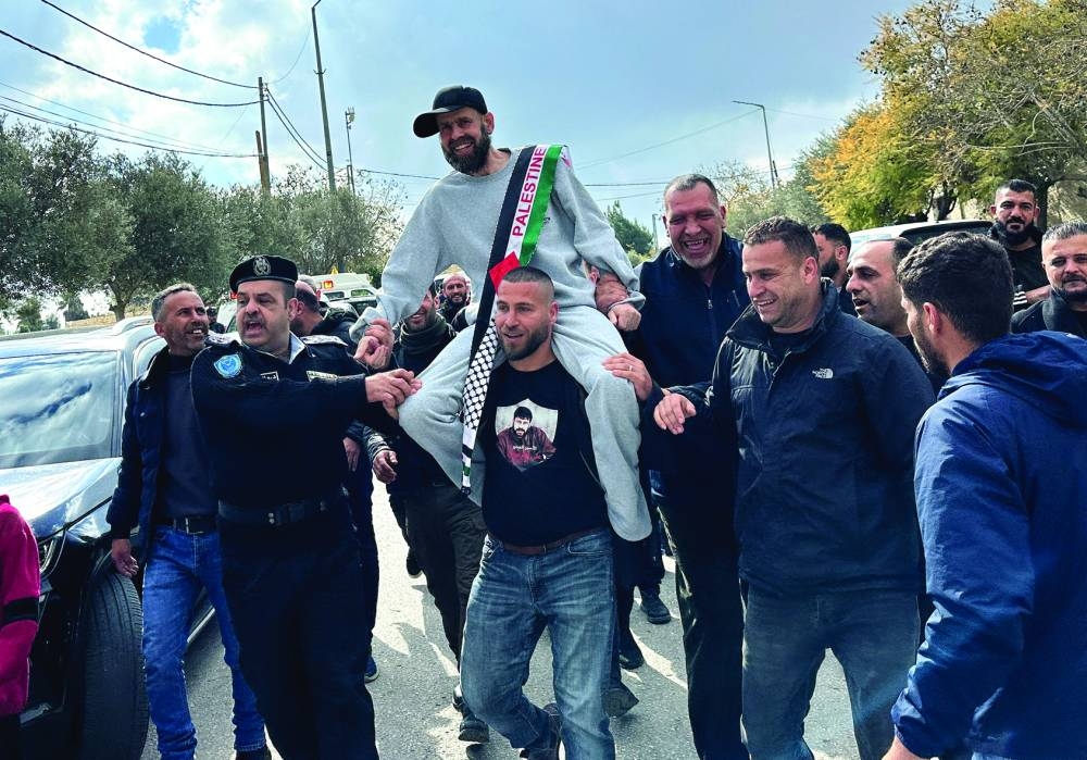 
A freed Palestinian prisoner is greeted after being released from an Israeli jail as part of a hostages-prisoners swap and a ceasefire deal in Gaza between Hamas and Israel, in Ramallah, in the Israeli-occupied West Bank, yesterday. 