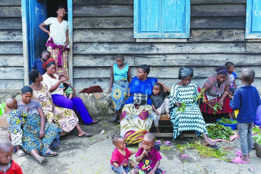 
Displaced people from Sake gather in front of a room where they are taking refuge with their families, following the intensification of fighting between M23 rebels and the Congolese army, in Goma, North Kivu province, in eastern DR Congo, yesterday. 