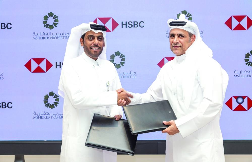 Engineer Ali Mohammed al-Kuwari, CEO of Msheireb Properties, and Abdul Hakeem Mostafawi, CEO of HSBC Qatar, shaking hands after the signing ceremony.