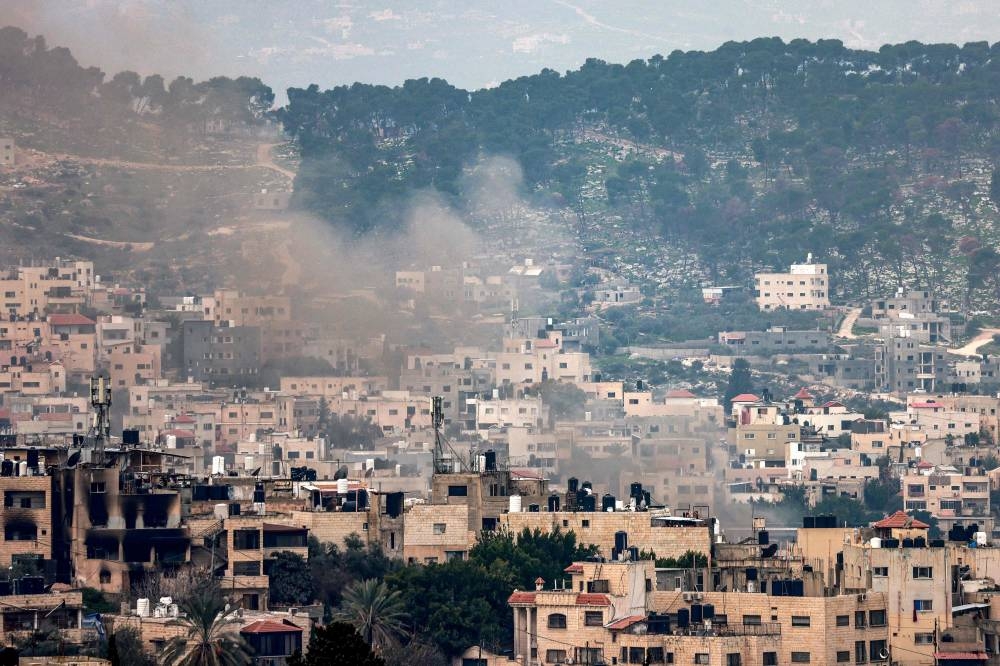 Smoke rises during an Israeli army operation in the Jenin camp for Palestinian refugees in the north of the occupied West Bank on Monday. AFP