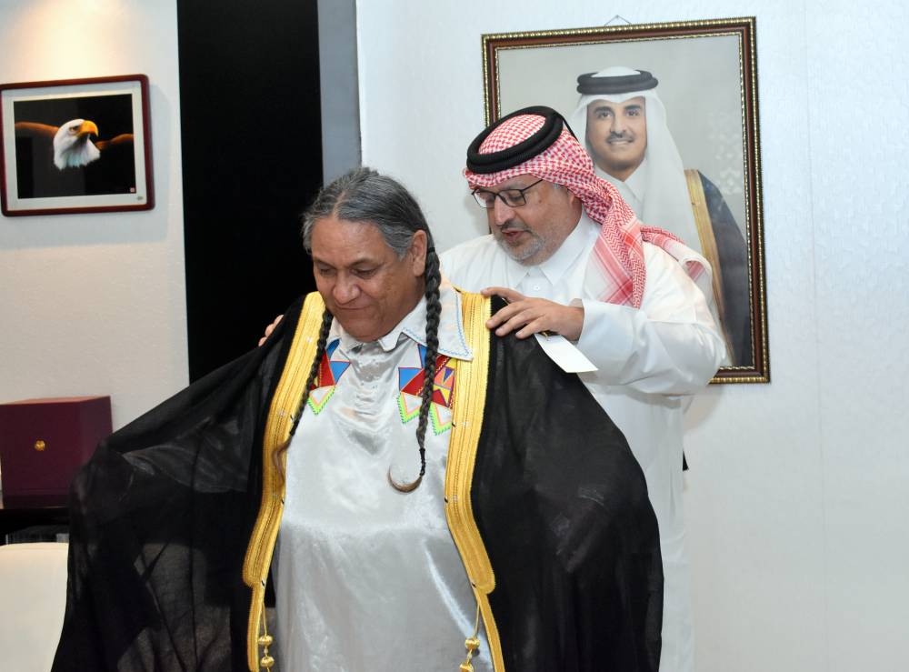 Gulf Times Editor-in-Chief Faisal Abdulhameed al-Mudahka draping the Qatari Bisht on Albert 'Nino' Reyos