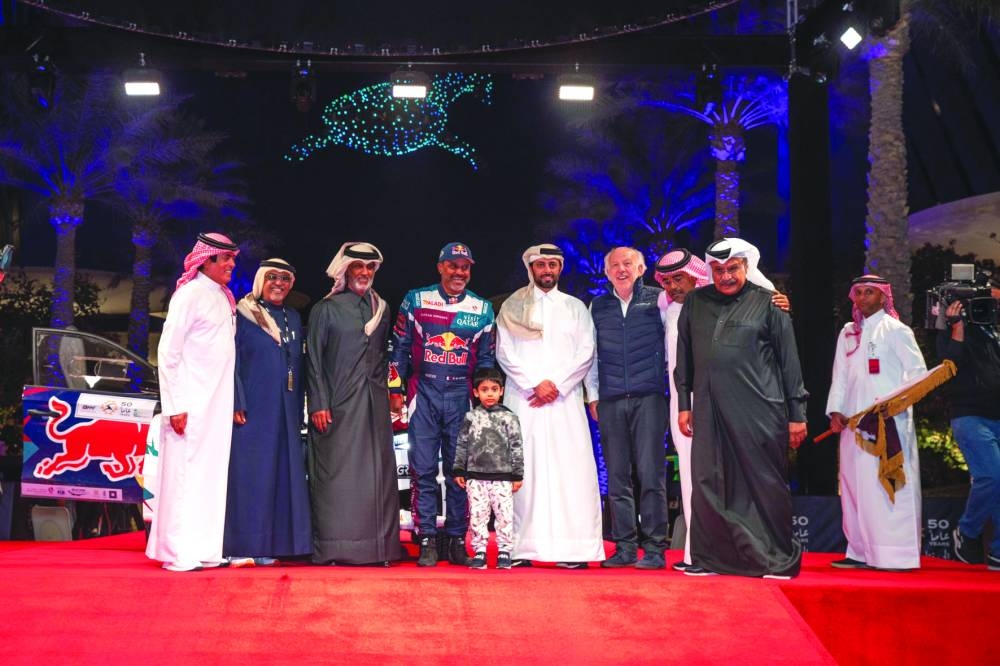 Minister of Sports and Youth HE Sheikh Hamad bin Khalifa bin Ahmed al-Thani, QMMF’s President Abdulrahman al-Mannai, Qatar’s rally ace Nasser Saleh al-Attiyah, rally legend Saeed al-Hajri, veteran drivers Sadoon al-Kuwari and Jaber al-Marri pose during the start ceremony of the Qatar International Rally at Lusail Boulevard on Thursday.