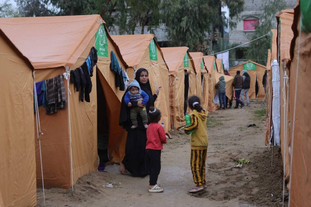 Displaced Palestinian families take refuge in tents installed near their damaged homes in Jabalia in the northern Gaza Strip on Thursday. AFP
