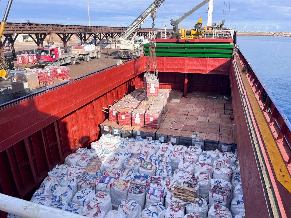 A crane loads humanitarian aid and food supplies for Gaza, sponsored by Misrata municipality and the Red Crescent, on a ship at the port of Misrata, Libya, on Wednesday. REUTERS