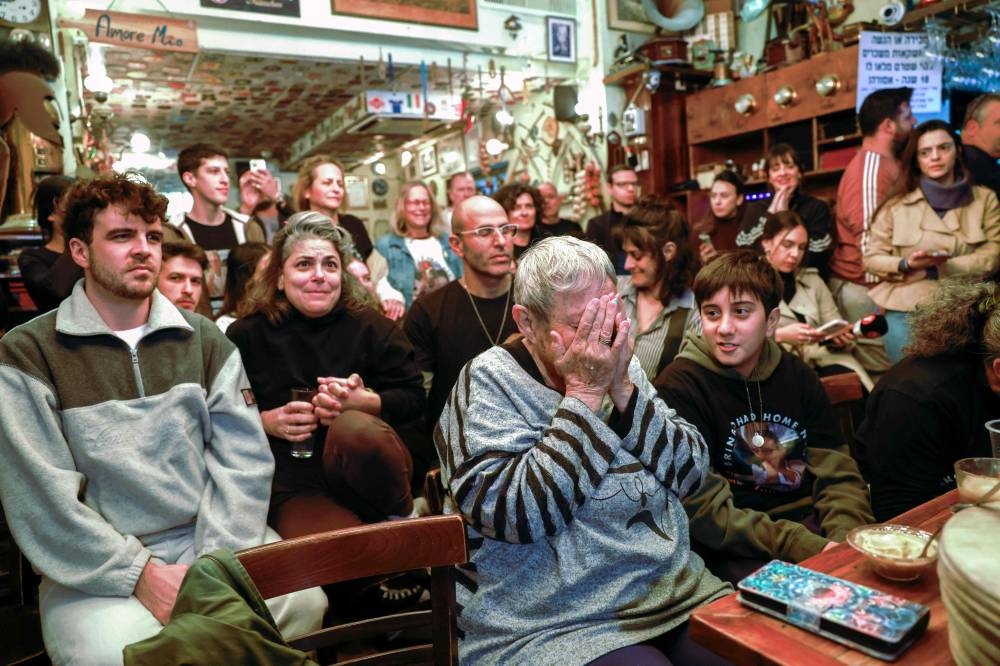 Friends and family of Israeli hostage Ohad Ben Ami, wait for news news that he would be released by Hamas Saturday,  in Tel Aviv. AFP