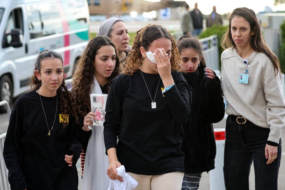 Relatives of newly-released Israeli hostage Eli Sharabi react as a military helicopter transporting him lands at the heliport of the Sheba hospital in Ramat Gan near Tel Aviv, on Saturday. AFP