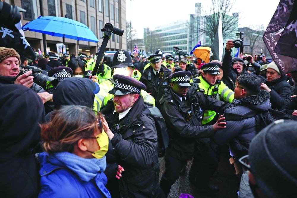 
Police jostle with protesters gathering yesterday at the site of the former Royal Mint in London to demonstrate against a proposal to move China’s embassy to this site, a stones-throw from The Tower of London. 