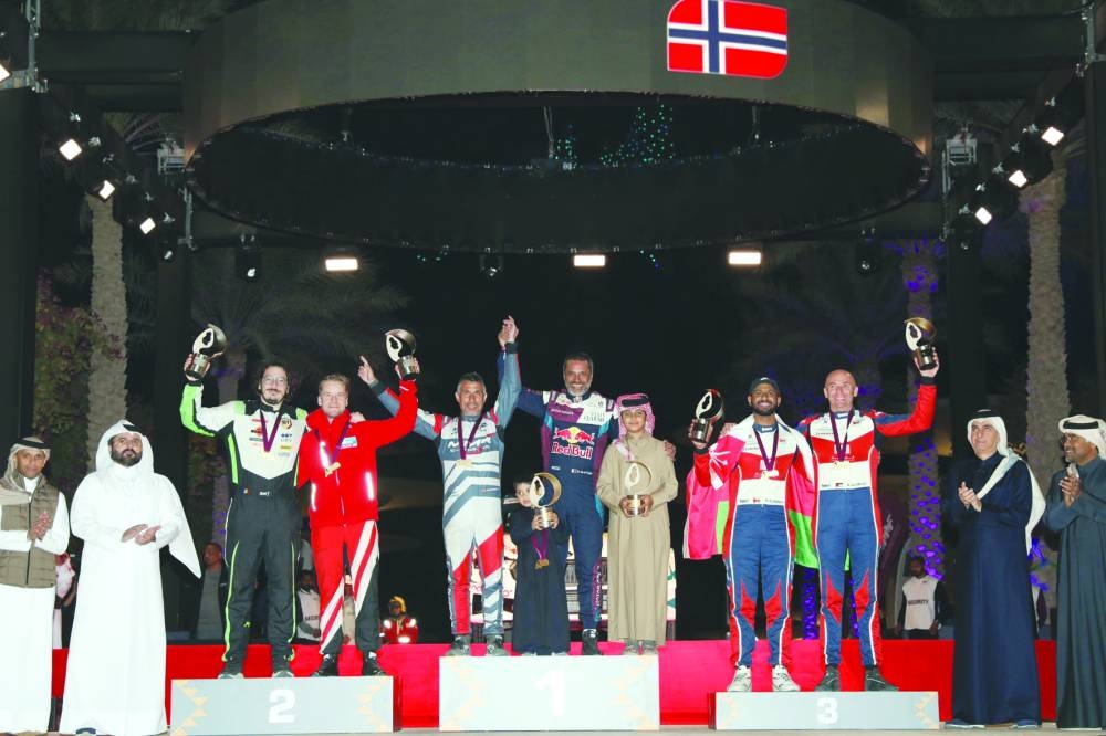 Nasser Saleh al-Attiyah and his co-driver Candido Carrera celebrate after winning the Qatar International Rally at Lusail Boulevard on Saturday. Mads Ostberg and Sergiu Itu finished second, while Abdullah al-Rawahi and Ata al-Hmoud were third.