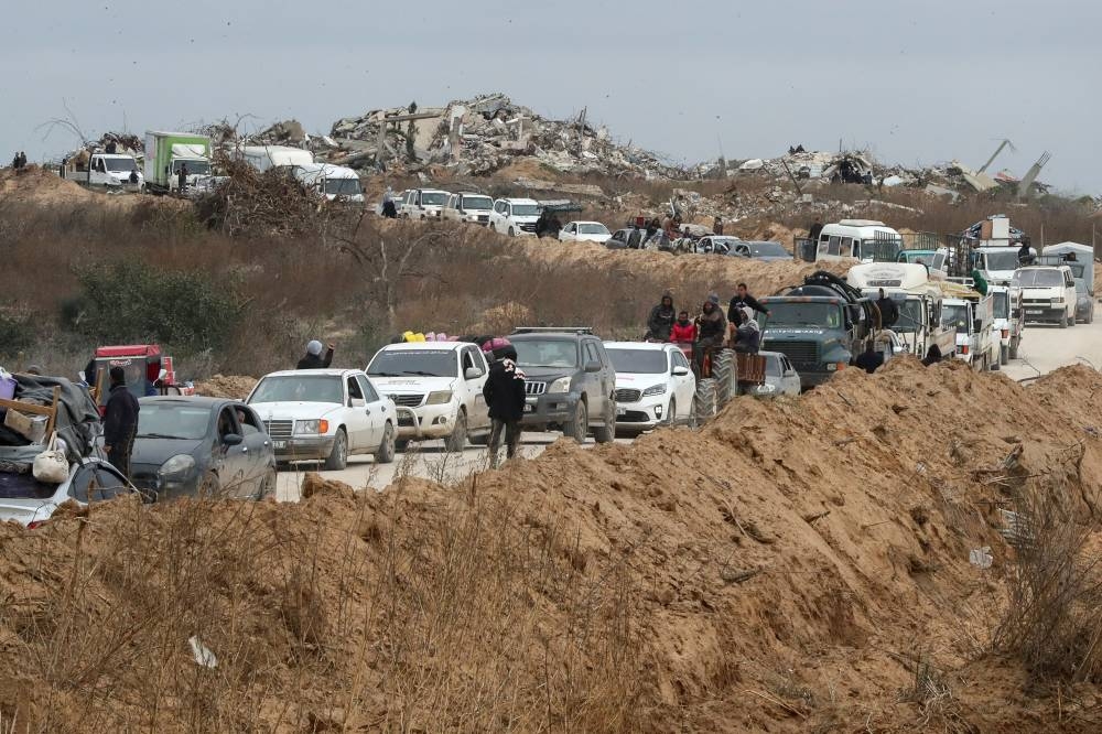 Palestinians wait to cross through a checkpoint run by US and Egyptian security contractors after Israeli forces withdrew from the Netzarim Corridor, allowing people to travel in both directions between southern and northern Gaza, near Gaza City, on Sunday. REUTERS
