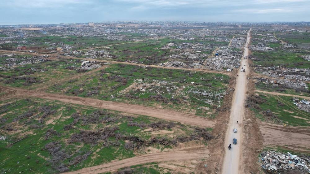 A drone view shows Palestinians making their way past the rubble after Israeli forces withdrew from the Netzarim Corridor, near Gaza City, on Sunday. REUTERS