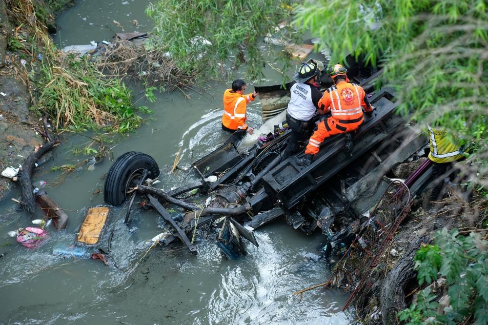 First responders work at the site of a deadly bus crash, in Guatemala City, Guatemala, on Monday. REUTERS