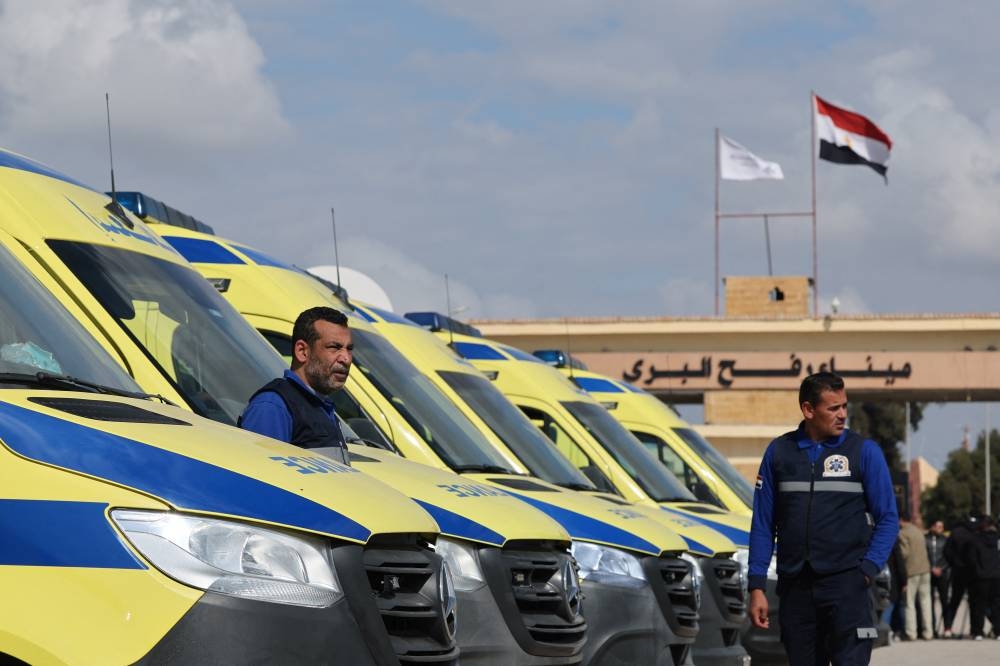 Egyptian ambulances are lined up on the Egyptian side of the Rafah border crossing between Egypt and the Gaza Strip, in Rafah, Egypt, on Tuesday. REUTERS