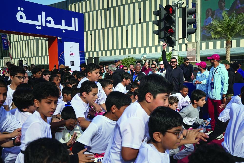 
HE Sheikh Joaan bin Hamad al-Thani, Qatar Olympic Committee President, shoots a starting pistol as children take part in 1km Fun Run as part of the QOC Half Marathon in Lusail. 