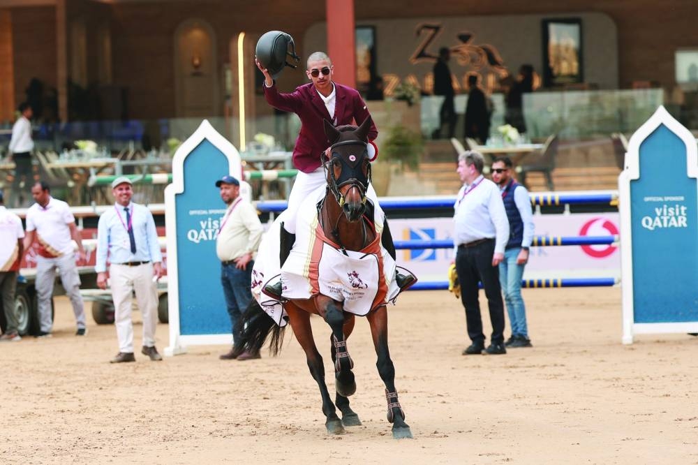 
Fahad Jassim H K al-Thani celebrates with his bay mare Ambre de Beaufour after winning the CSI3* 1.35m class. 
