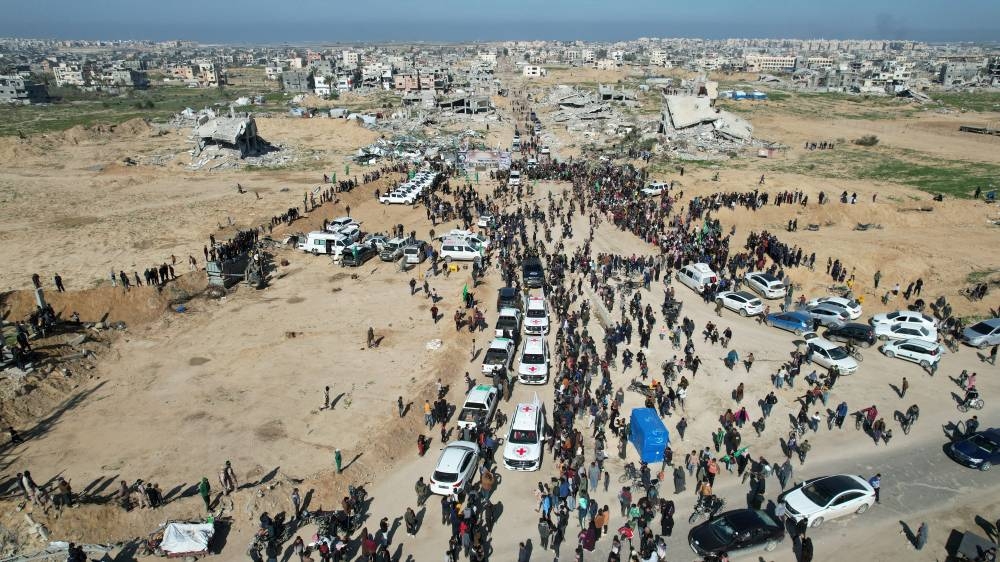 A drone view shows Palestinians gathering near Red Cross vehicles on the day Palestinian Hamas and Islamic Jihad release hostages held in Gaza since the deadly October 7, 2023 attack, on Saturday. REUTERS