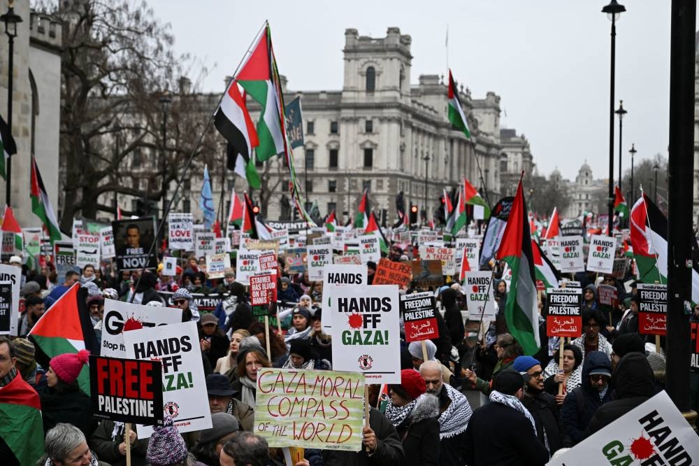 Pro-Palestinian demonstrators attend a march in opposition to US President Donald Trump's plan to displace Palestinians from Gaza and "take over" the territory, in London, on Saturday. REUTERS