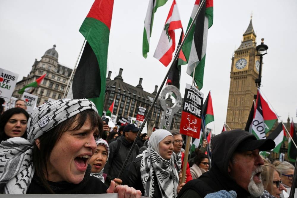 Pro-Palestinian demonstrators attend a march in opposition to US President Donald Trump's plan to displace Palestinians from Gaza and "take over" the territory, in London, on Saturday. REUTERS