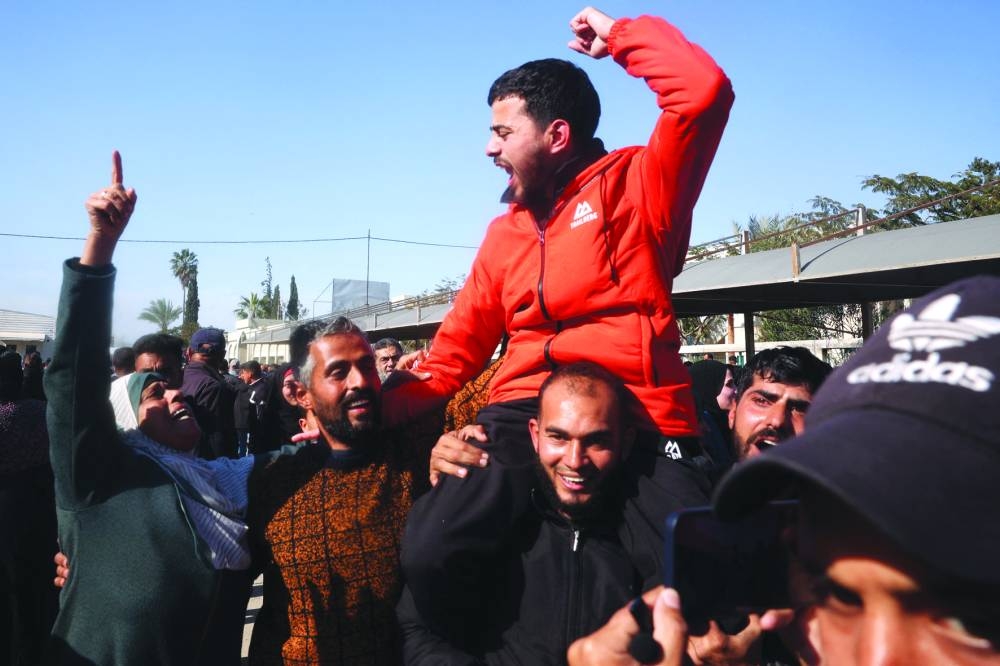 A former Palestinian prisoner, released as part of the sixth hostage-prisoner exchange, is welcomed by friends and relatives upon arriving at the European Hospital in Khan Yunis in the southern Gaza Strip, yesterday.
