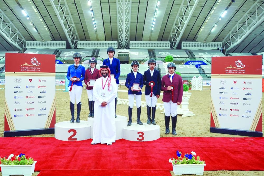 
Mohammed Jaber al-Khayarin, Event Director, poses with the top six finishers of the Future Riders’ National Competition 100cm. Naylah bint Tamim bin Hamad al-Thani emerged triumphant in the event. 