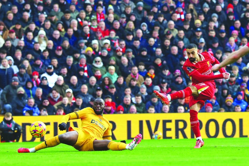 Liverpool’s Egyptian striker Mohamed Salah (right) in action during the English Premier League match against Wolverhampton Wanderers at Anfield in Liverpool, north west England, yesterday. (AFP)