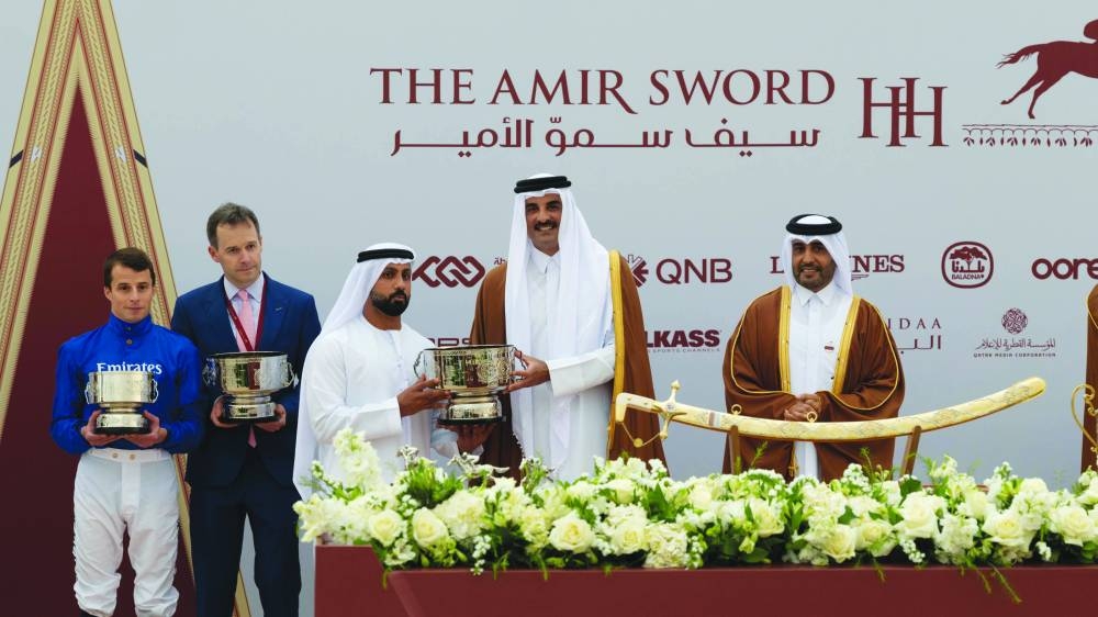 
His Highness the Amir Sheikh Tamim bin Hamad al-Thani presented the HH The Amir Trophy - presented by Longines - to CEO of Dubai Racing Club Ali al-Ali, who received the trophy on the behalf of Godolphin, owner of Rebel’s Romance, the winner of the race. QREC Chairman Issa bin Mohammed al-Mohannadi and President of the Asian Equestrian Federation and Vice-Chairman of QREC Hamad bin Abdulrahman al-Attiya were also present on the occasion at the Al Uqda Racecourse yesterday.  