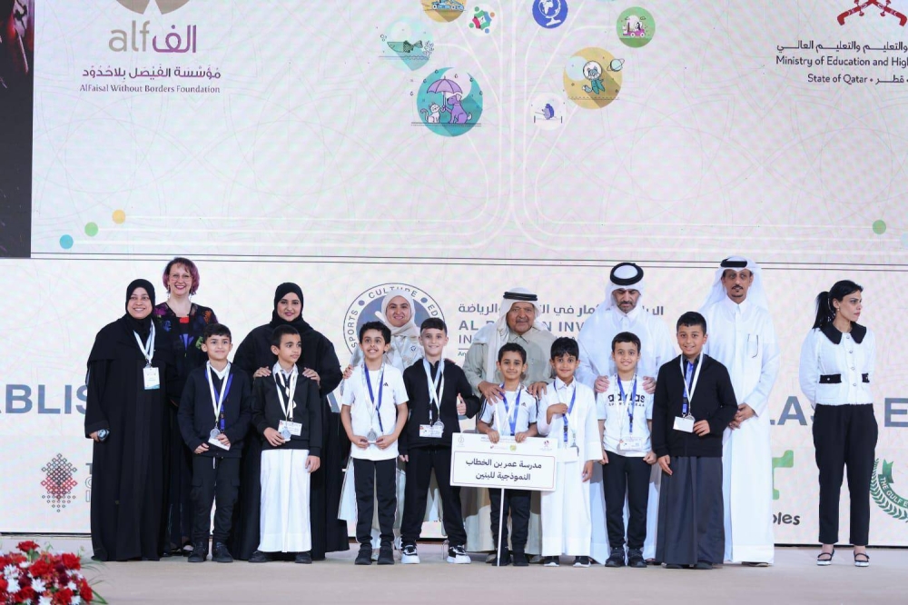Participants from the Omar Bin Al-Khattab Model School for Boys with officials.