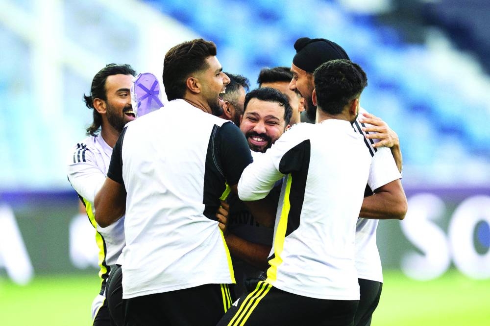 
India’s captain Rohit Sharma (centre) celebrates with his teammates as he plays a game with a soccer ball during a practice session at the Dubai International Stadium ahead of their ICC Champions Trophy match against Bangladesh to be played today. (AFP) 