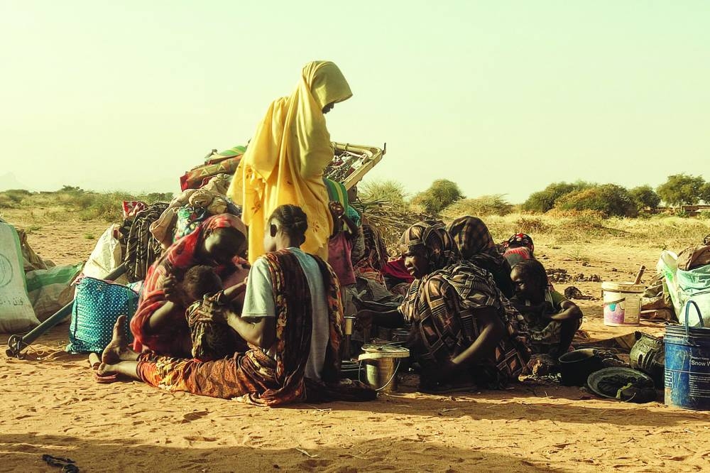 
Displaced Sudanese, who fled the Zamzam camp, gather near the town of Tawila in North Darfur. 