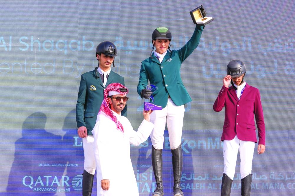 
Saudi Arabia’s Abdullah Alsharbatly receives the trophy from Abdullah al-Qashouti, Director of Communications and Marketing of CHI Al Shaqab, after winning the CSI1* - Faults & Time - 1.20m - GP Qualifier class. Saudi’s Khaled Alhady finished second, while Qatar’s Fahad Jassim HK al-Thani claimed third spot. 