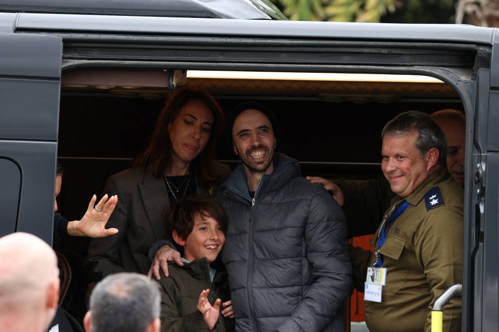 Tal Shoham, a hostage, reacts inside a van after he was released from captivity at Beilinson Schneider complex in Petah Tikva, Israel, on Saturday. REUTERS