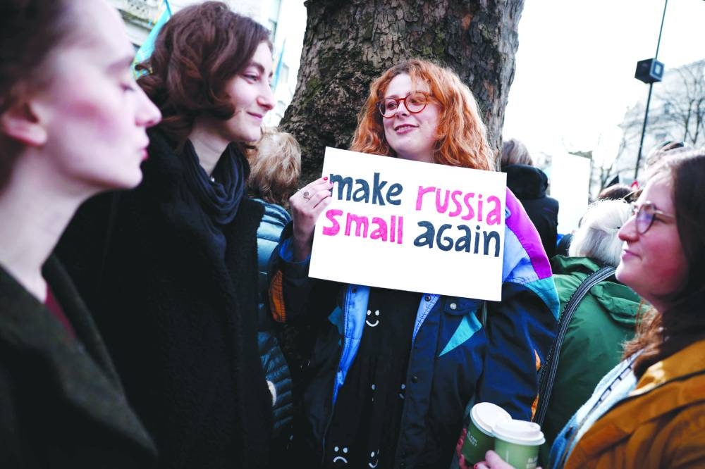 
A protester holds a placard reading “Make Russia small again” as people gather in central London for a march in support of Ukraine. 