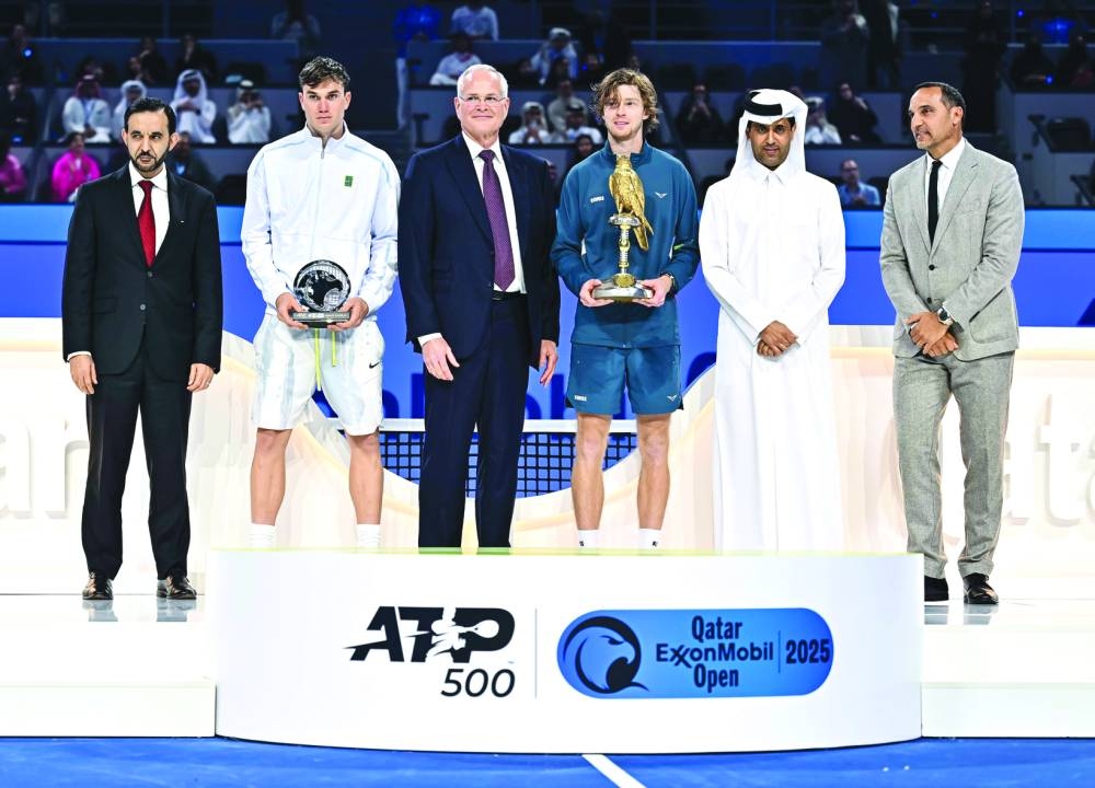Russian Andrey Rublev celebrates with the trophy alongside Chairman and Chief Executive Officer of Exxon Mobil Corporation Darren Woods, President of QTSBF Nasser bin Ghanim al-Khelaifi, runner-up Jack Draper of Britain and other officials after winning the Qatar ExxonMobil Open on Saturday. PICTURES: Noushad Thekkayil