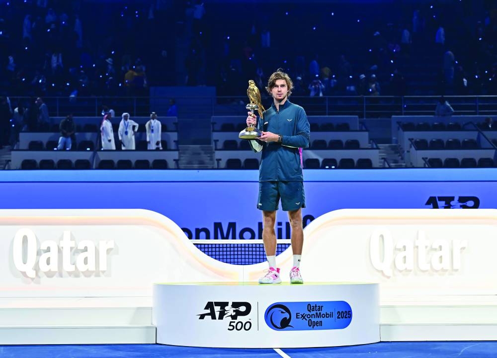 Andrey Rublev of Russia poses with the trophy after winning against Jack Draper of Britain in the Qatar ExxonMobil Open final in Doha on Saturday.