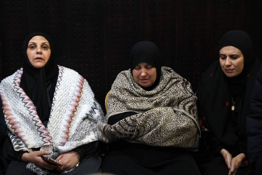 Palestinian families react after Israel delayed the release of Palestinian prisoners, scheduled to be released in the seventh hostage-prisoner exchange, in the occupied West Bank city of Ramallah early on Sunday. AFP