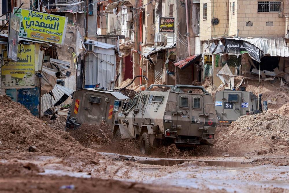 Israeli armoured vehicles drive through the Jenin camp for Palestinian refugees in the occupied West Bank Monday.