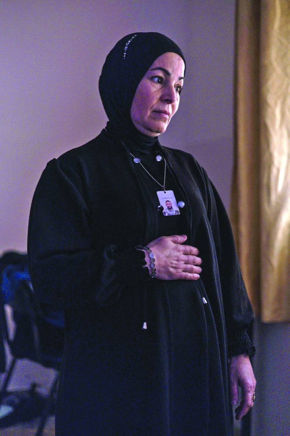 Sanaa Shraim, a displaced Palestinian from the Jenin refugee camp who claims to have lost her son during an Israeli military raid in 2023, poses for a portrait in a room inside a community centre in the occupied West Bank city of Jenin.