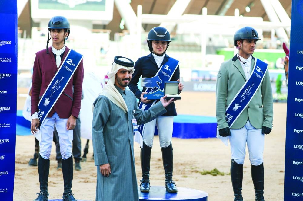 
Qatar’s rising talent Haya al-Hitmi receives her award from Abdullah al-Qashouti, Marketing and Communications Manager of the Doha LGCT Championship, after winning the FEI Group 7 qualifying CSIJ-B with Jump-off (1.25m) class. 