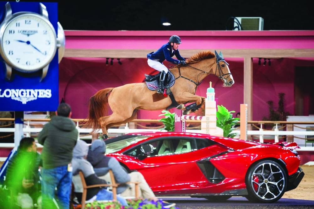 
German rider Hans-Dieter Dreher, astride chestnut gelding Vestmalle des Cotis, clears a hurdle en route to winning the CSI5* 1.50m class at Al Shaqab. 