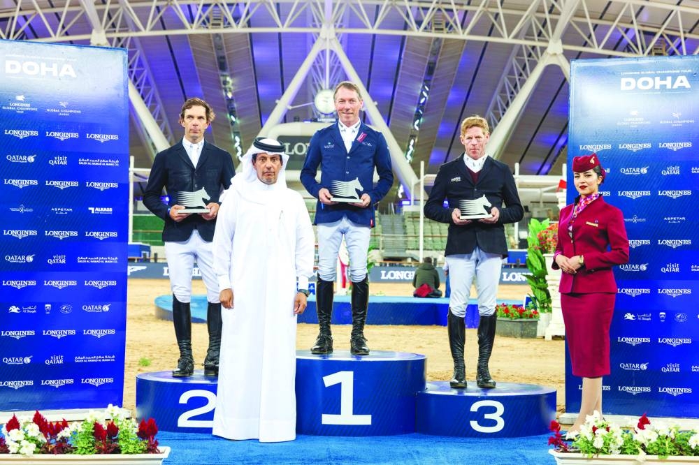 
Hamza al-Kuwari, Director of Corporate Services at Al Shaqab and member of the Organising Committee, poses with the podium winners of the 1.50m jump-off class. 