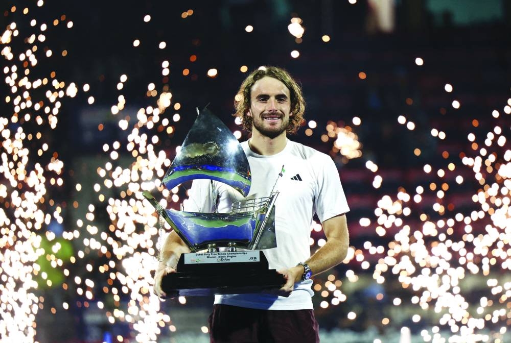 Greece’s Stefanos Tsitsipas celebrates with trophy after winning the Dubai Championships final against Canada’s Felix Auger-Aliassime in Dubai on Saturday. (Reuters)
