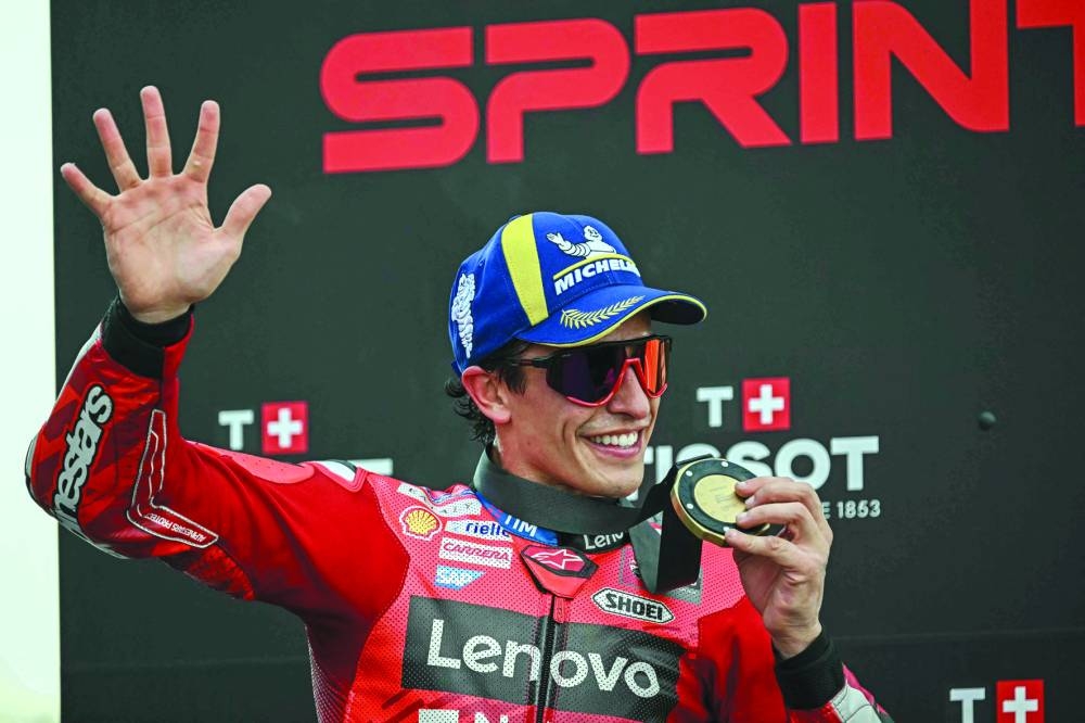 
Marc Marquez celebrates on the podium after winning the Sprint race of the MotoGP Thailand Grand Prix. (AFP) 