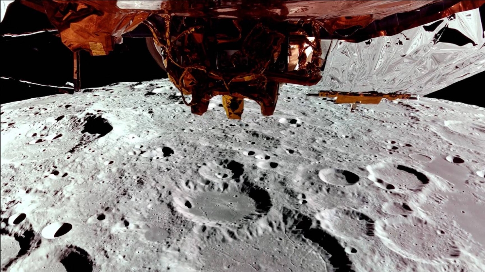 Firefly's Blue Ghost lander on its third lunar orbit, showing the far side of the Moon and a top-down view of Blue Ghost. Firefly Aerospace/AFP