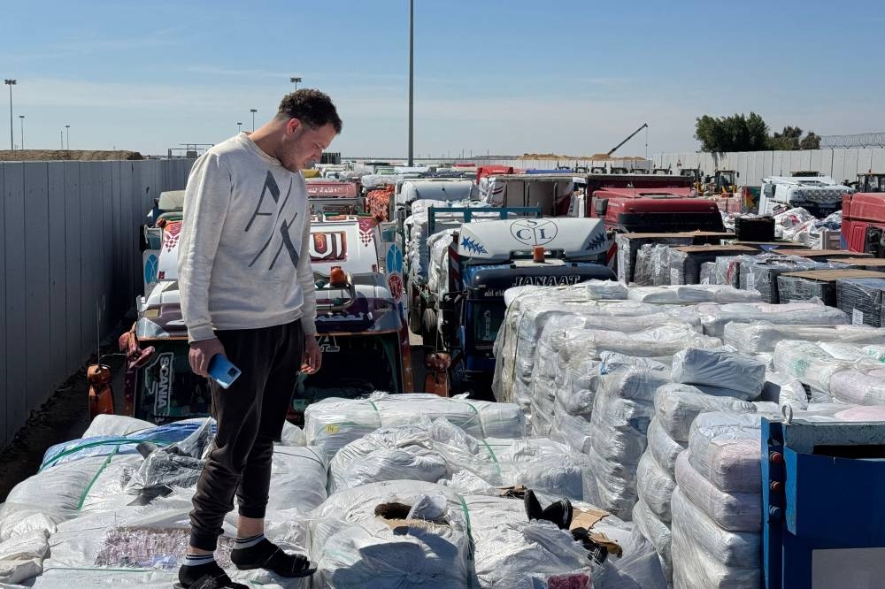 Trucks carrying humanitarian aid line up on the Egyptian side of the Rafah border crossing with the Gaza Strip on Sunday, after Israel suspended the entry of supplies into the Palestinian enclave. AFP
