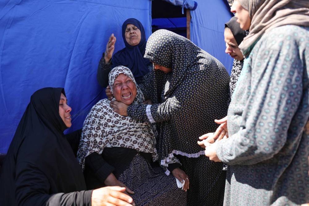 Relatives mourn two Palestinians killed in a reported Israeli strike in Beit Hanun in the northern Gaza Strip on Sunday. AFP