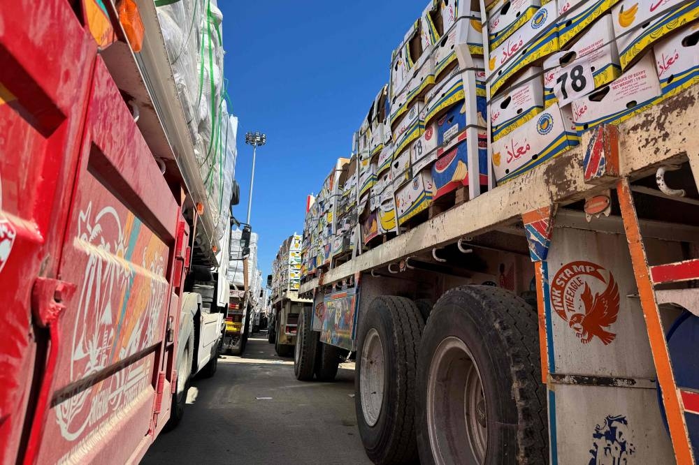 Trucks carrying humanitarian aid line up on the Egyptian side of the Rafah border crossing with the Gaza Strip on Sunday, after Israel suspended the entry of supplies into the Palestinian enclave. AFP