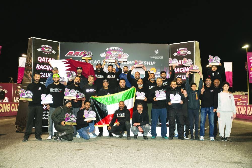 
All the winners of the second round of the QDRC celebrate on the podium. 