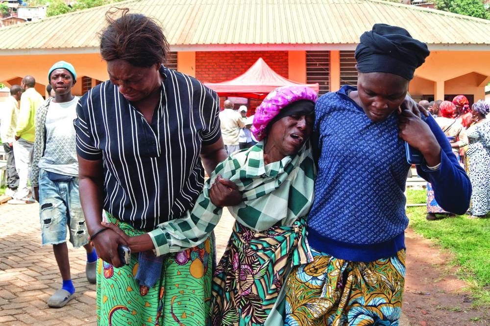 
Family members comfort another grieving member in Bukavu yesterday during funeral proceedings of victims of the February 27 explosions at an M23 movement meeting. 