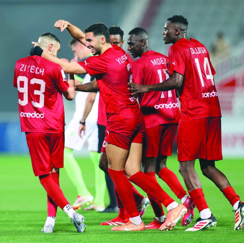 Al Duhail’s Hakim Ziyech (left) celebrates with teammates after scoring against Al Ahli at the Abdullah Bin Khalifa Stadium on Saturday.